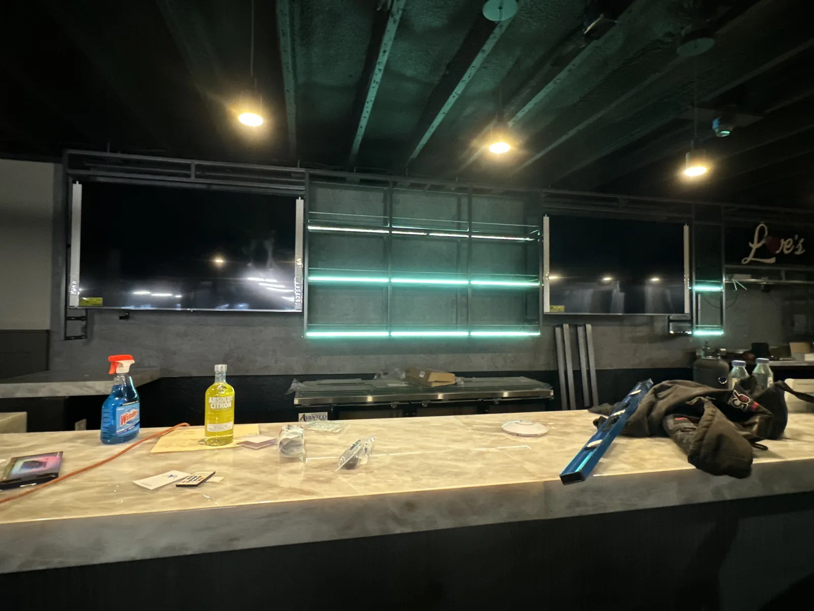 Back bar with a mounted TV and LED-lit shelving