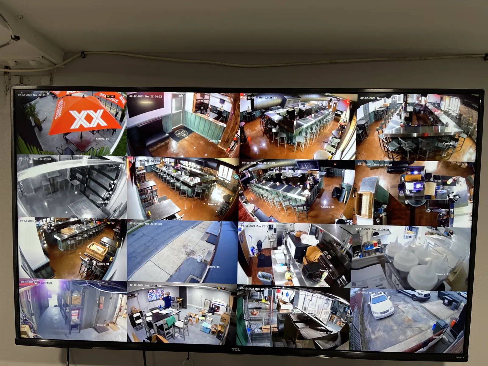 Monitor showing a grid of restaurant security camera views