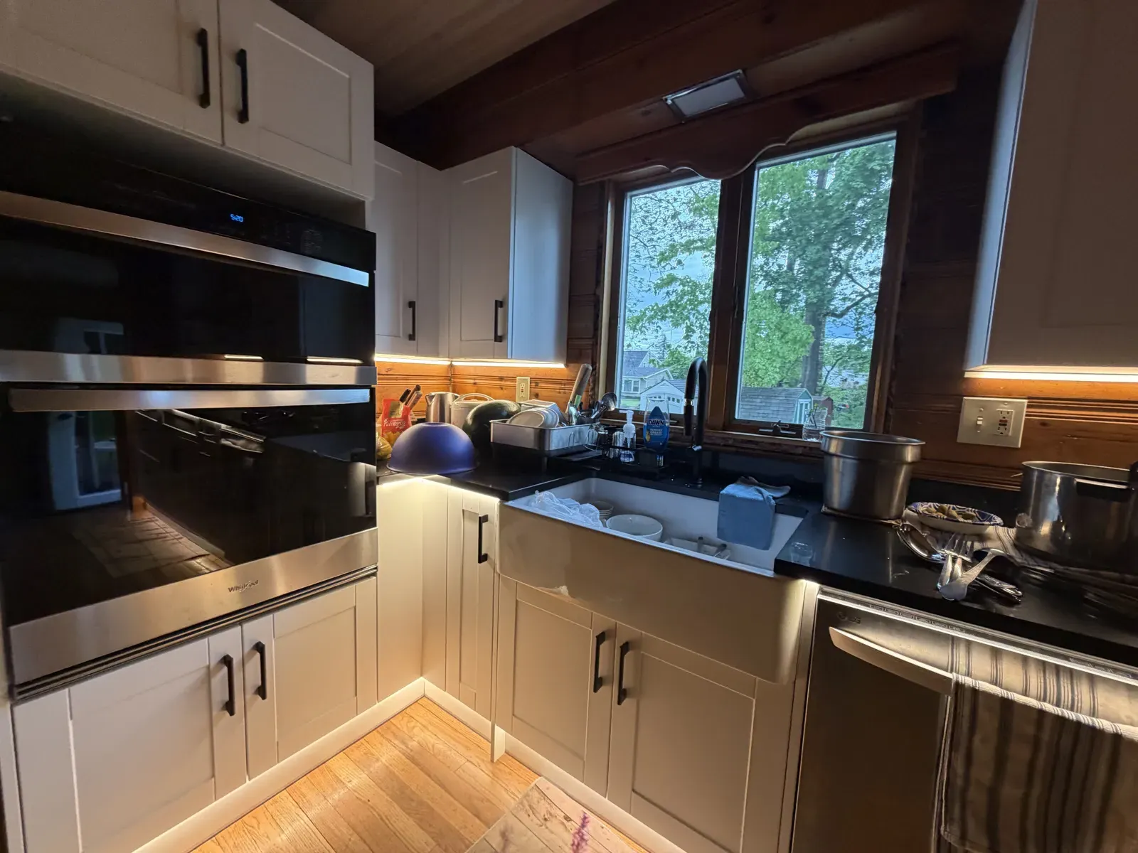 Lit cabinets and toe-kick lighting beside the wall ovens